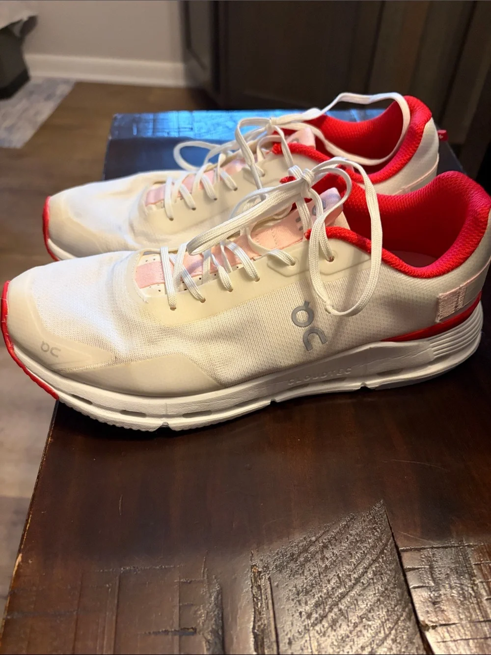 On Running White Athletic Shoes with Pink and Red Accents